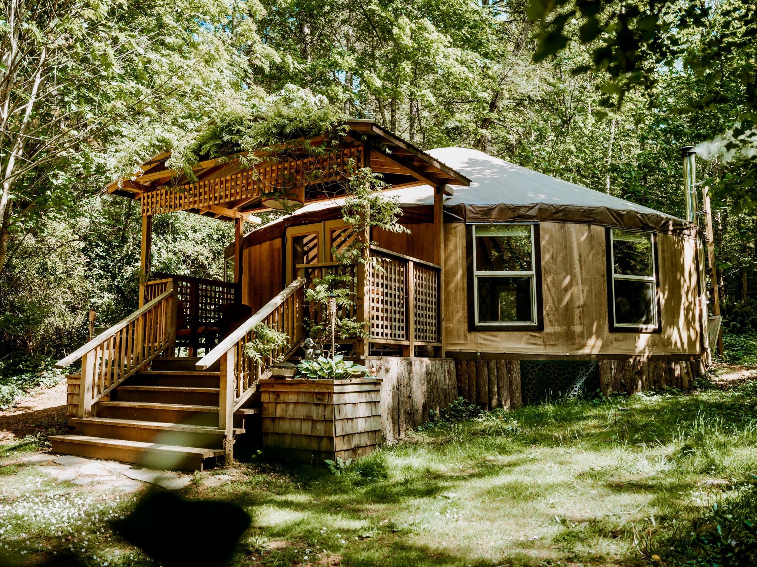 Ravenbrook Yurt, a wooden yurt among the trees outside Victoria, BC.